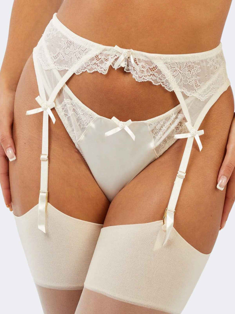 model wearing white florral lace garter belt with three satin bows and ivory color stockings front